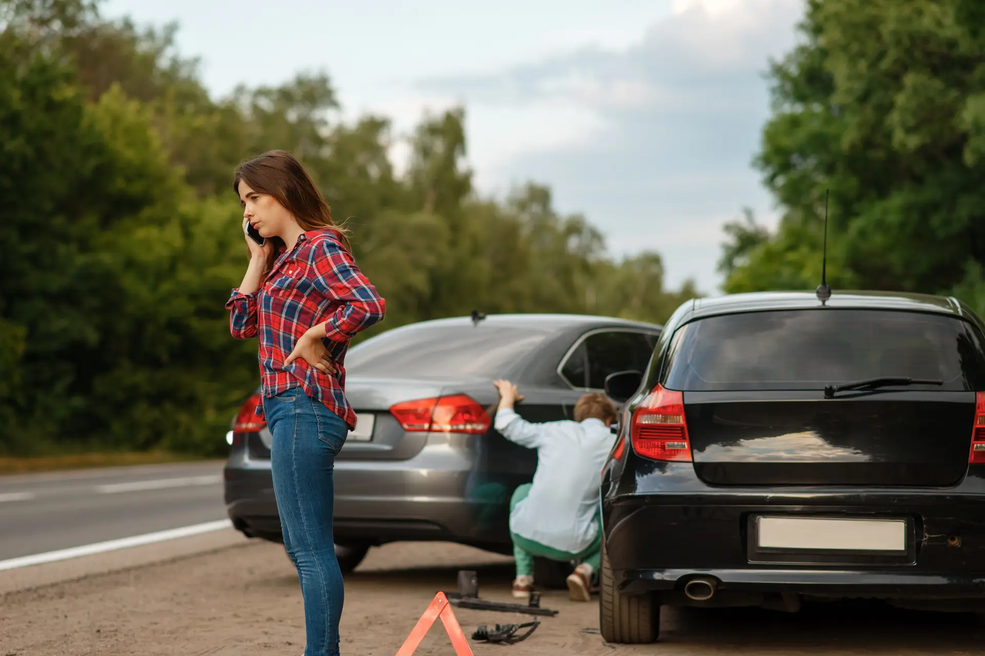 A woman talking on the phone after a car accident