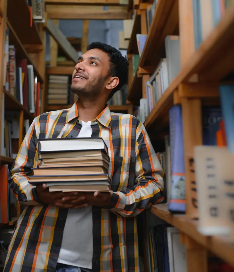 student holding lots of books