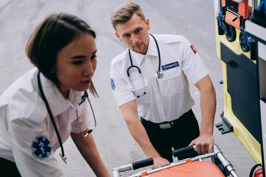 medics help person get into ambulance vehicle