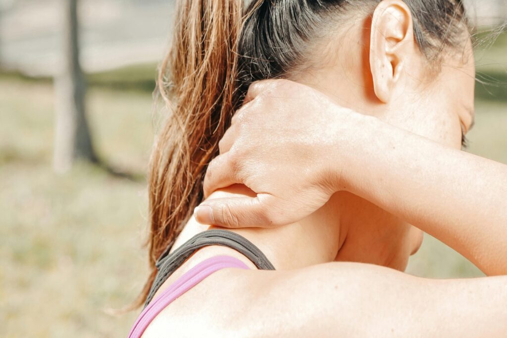 women hold her neck after injury