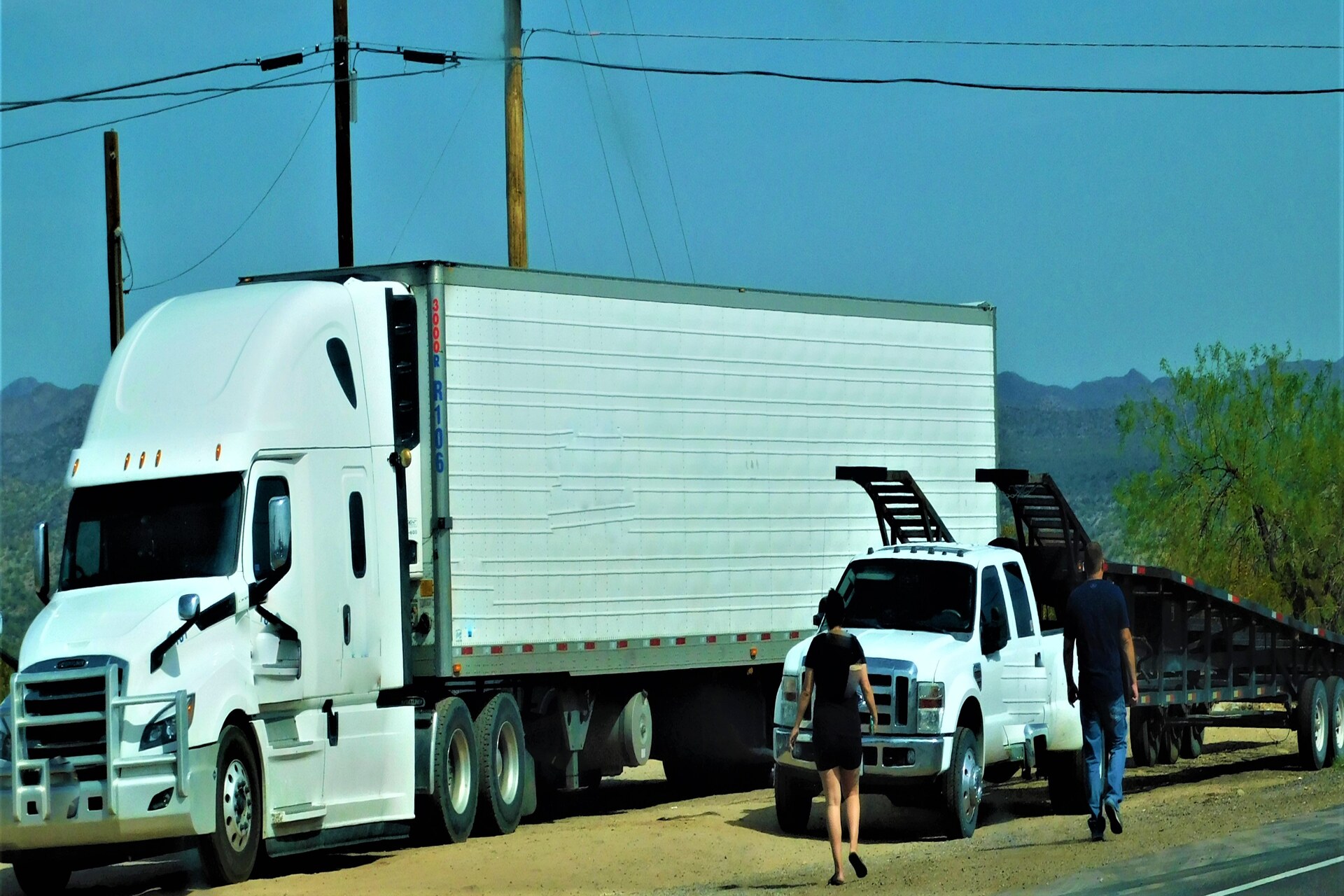 car and truck parked at the side of the road