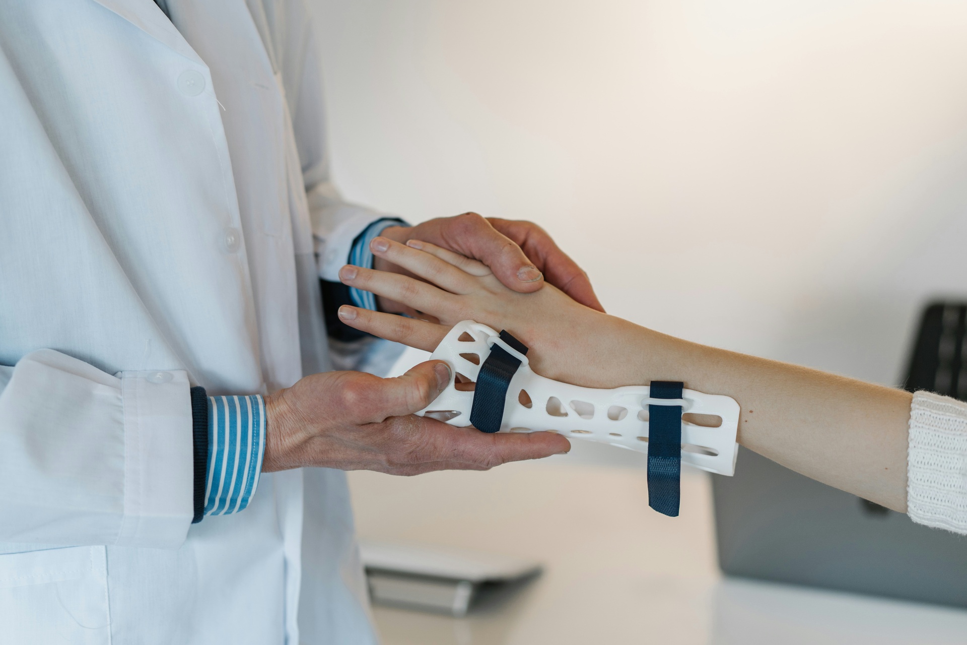 Doctor holding wrist in pain