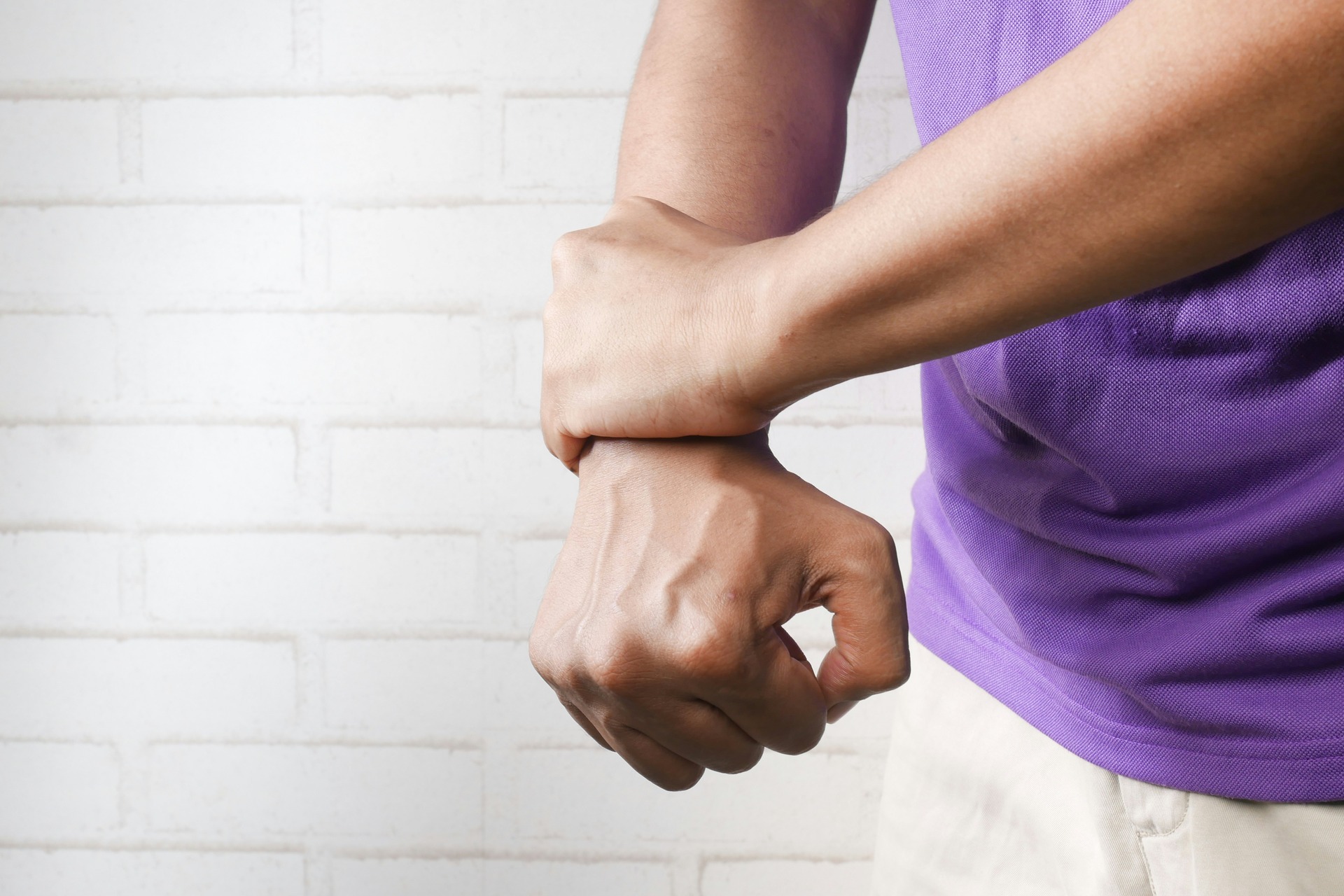 Man holding wrist in pain