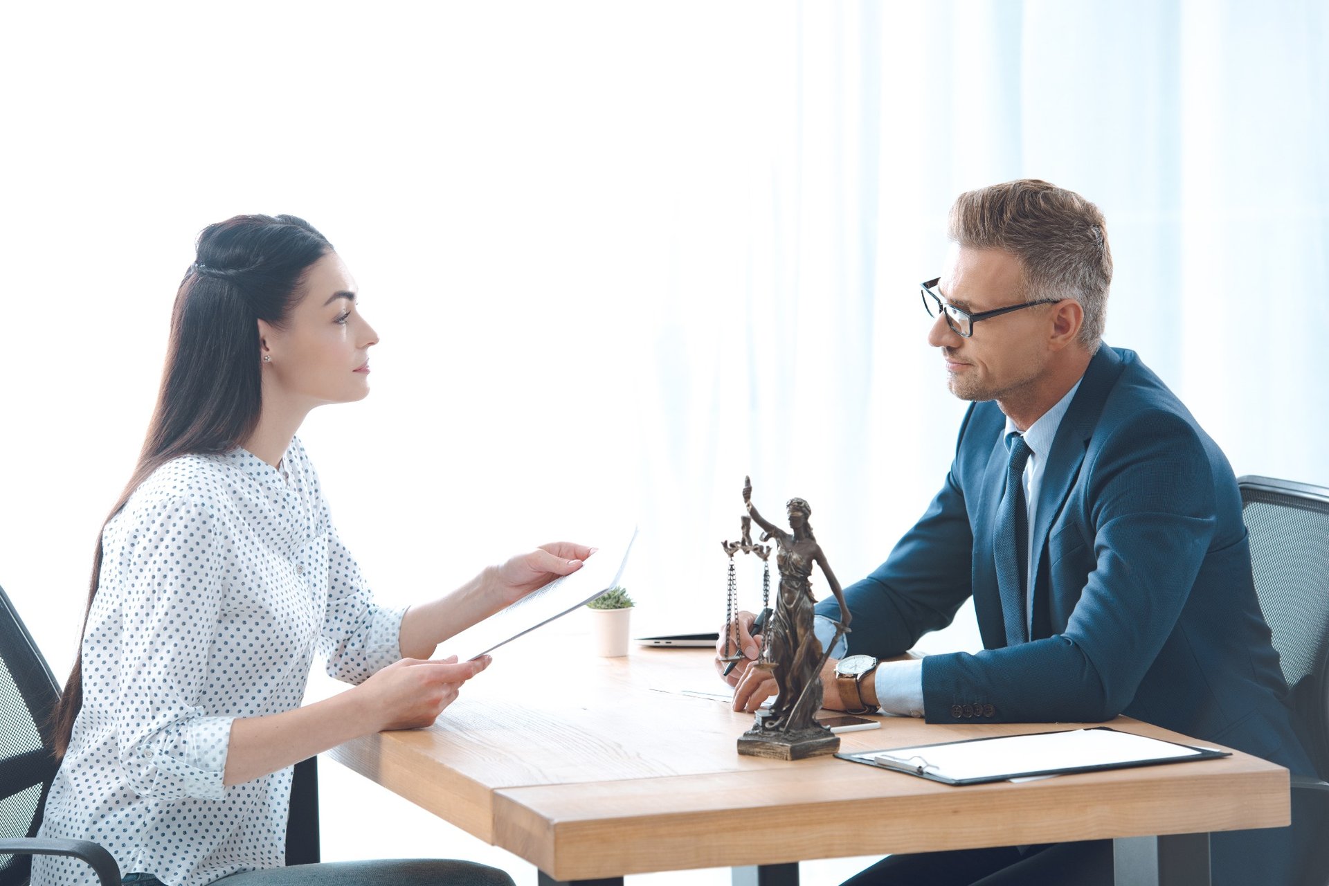 Client and attorney reviewing paperwork in office setting
