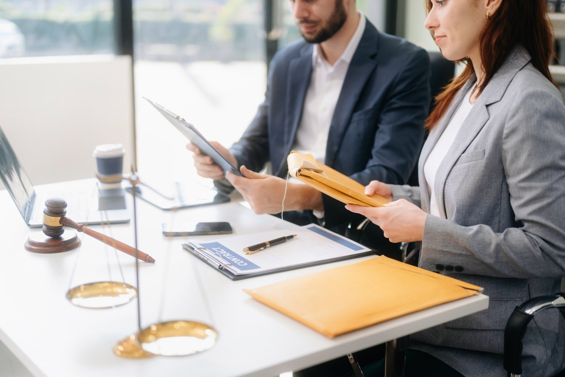 Professional legal team reviewing documents at modern office desk