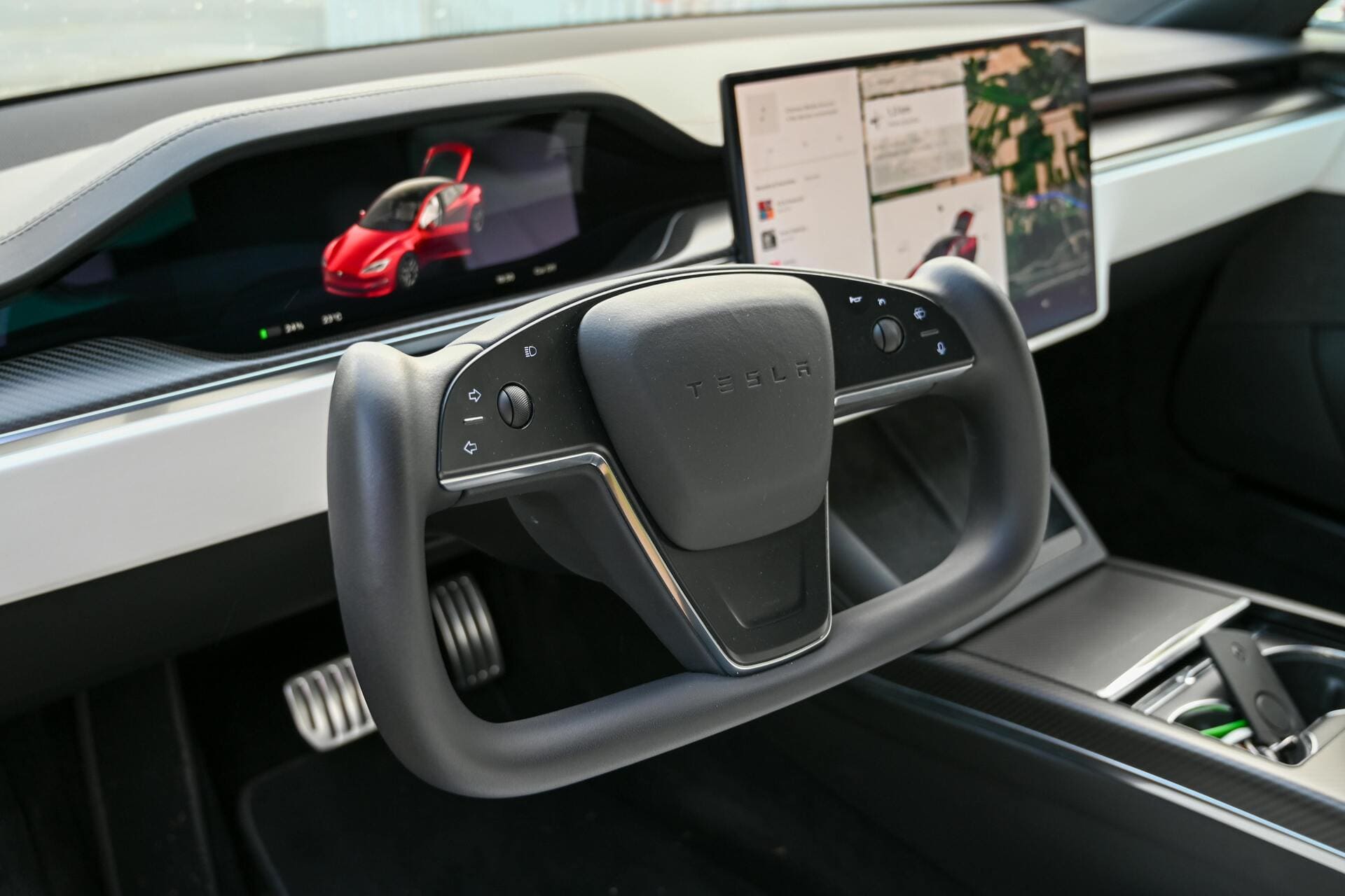 Interior view of a Tesla Model S with a yoke-style steering wheel