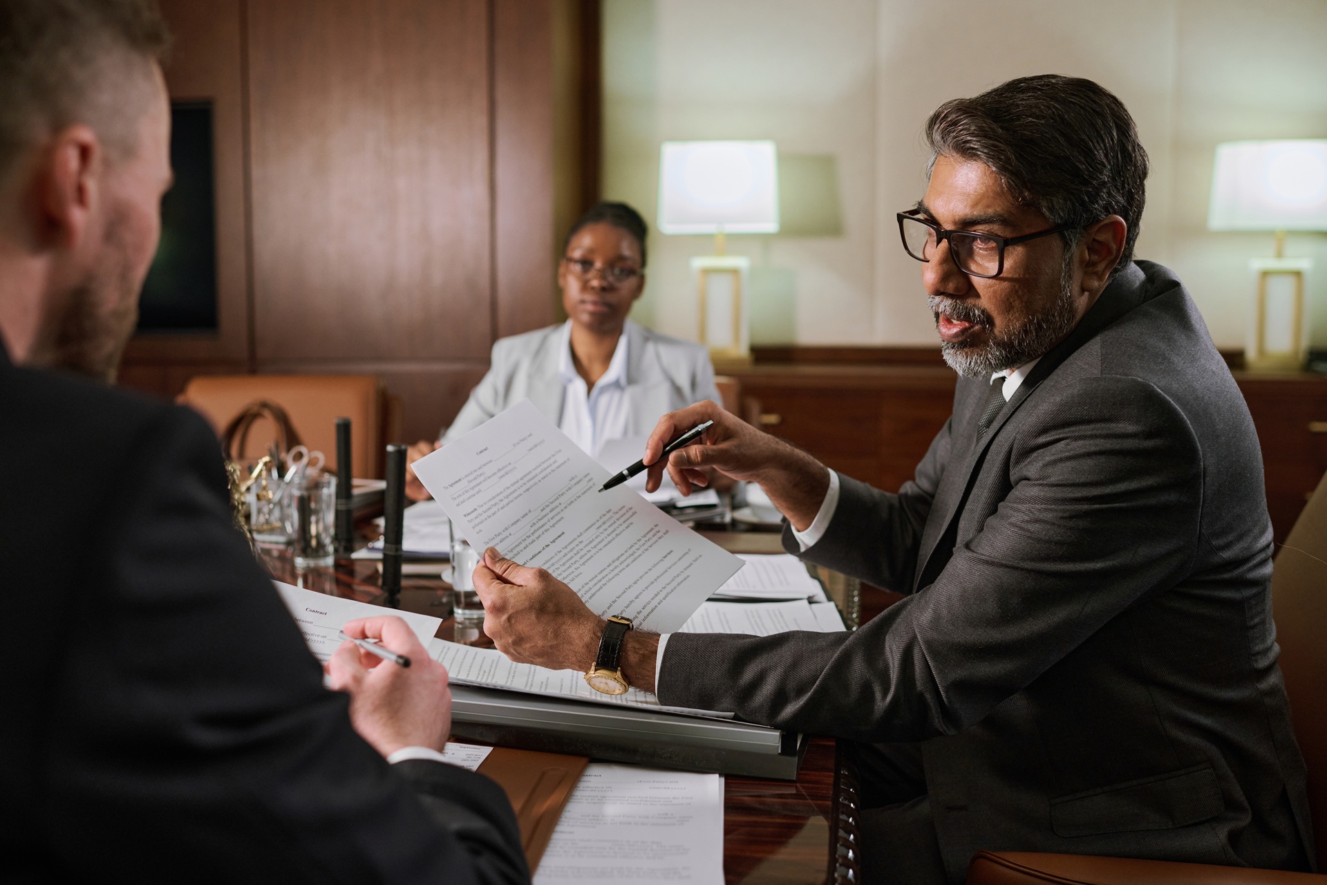 Lawyer explains details of a legal document during a business meeting with colleagues